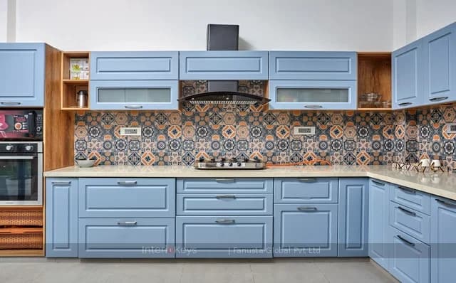 L-Shaped Kitchen with Blue Cabinets and Patterned Tiles