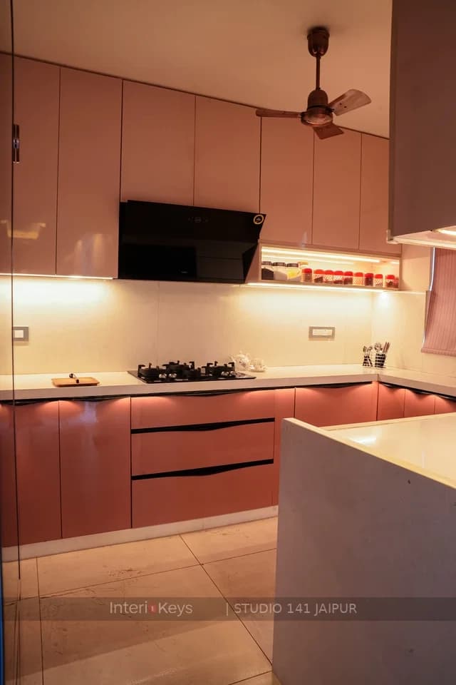 Glossy Pink U-Shaped Kitchen with Black Chimney