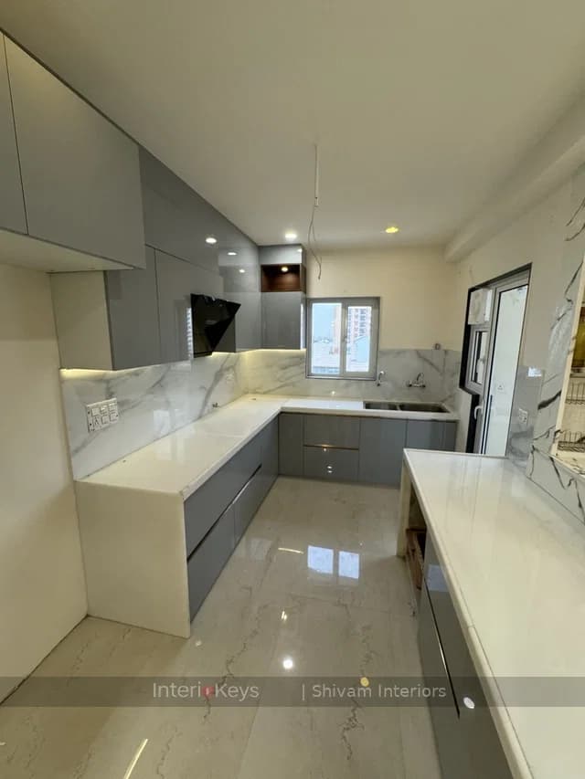 U-Shaped Grey Kitchen with Marble Counter and Breakfast Bar