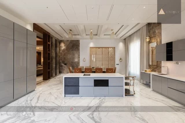 U-Shaped Grey Kitchen with Marble Island and Chandelier