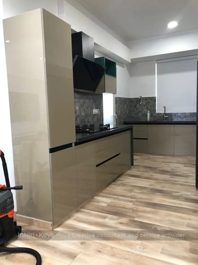 L-Shaped Kitchen with Glossy Cabinets and Black Chimney