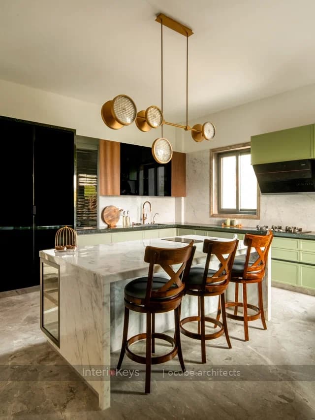 L-Shaped Kitchen with Marble Island and Sage Cabinets