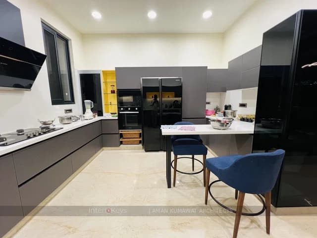 U-Shaped Kitchen with Grey Cabinets and Breakfast Counter