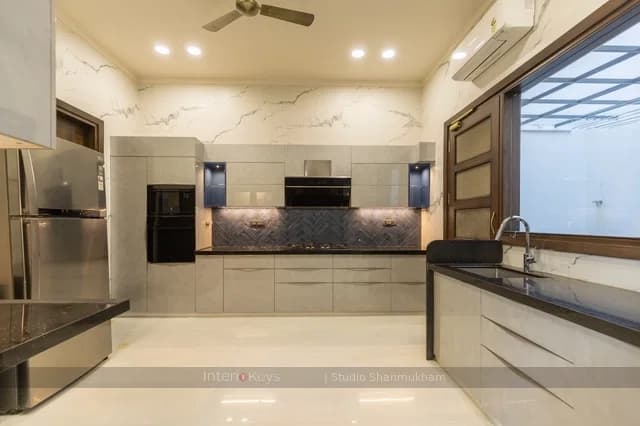 L-Shaped Kitchen with Herringbone Backsplash